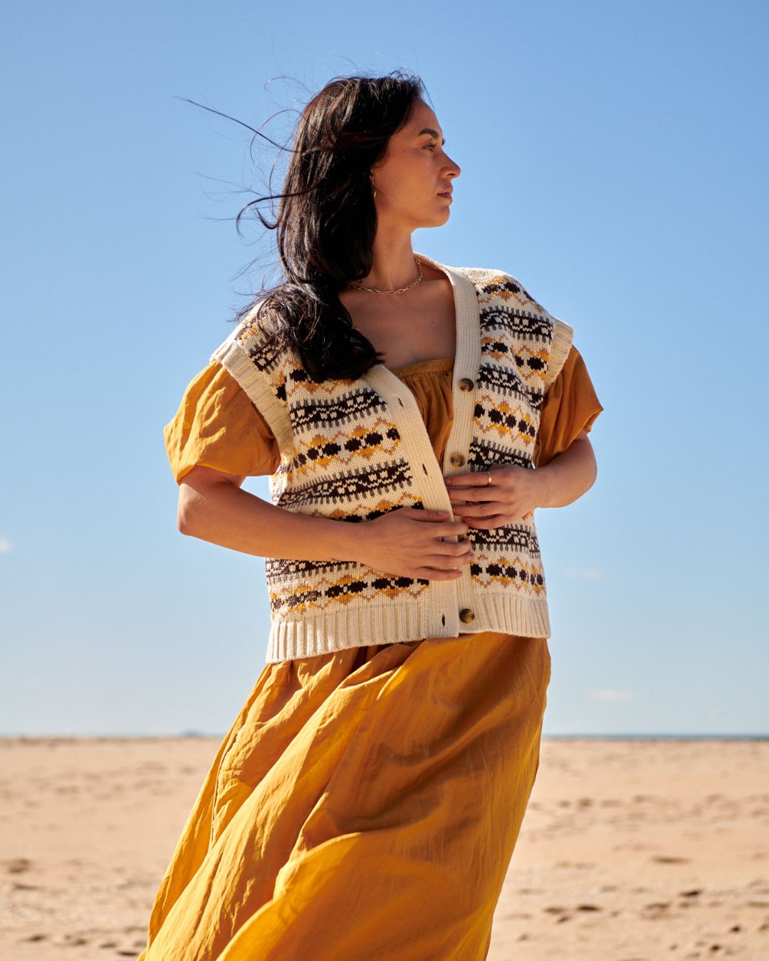 A model wearing a knit vest