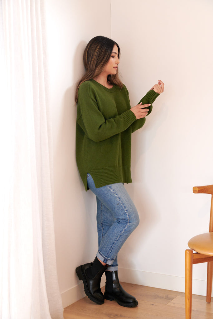 Green sweater black on sale jeans